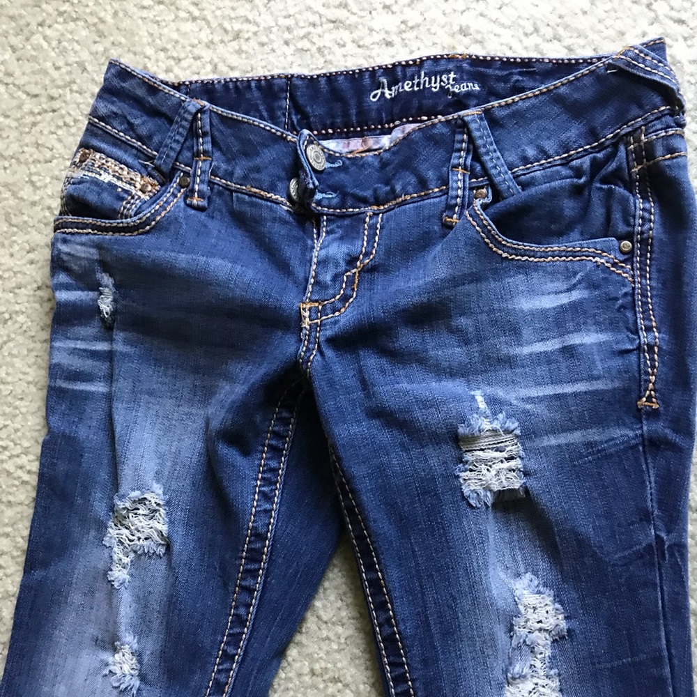 Low rise boot cut distressed jeans